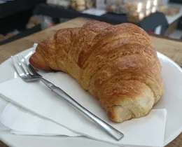 A freshly baked, flaky croissant