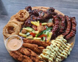 A loaded grill platter with ribs, wings and chicken strips