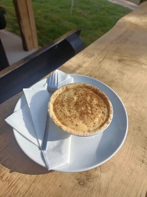 Slice of melktert dusted with cinnamon