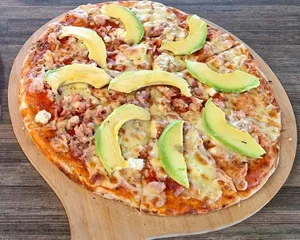 Avocado and bacon pizza on a wooden board