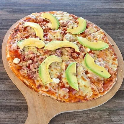 Stone-baked bacon and avocado pizza on a wooden board