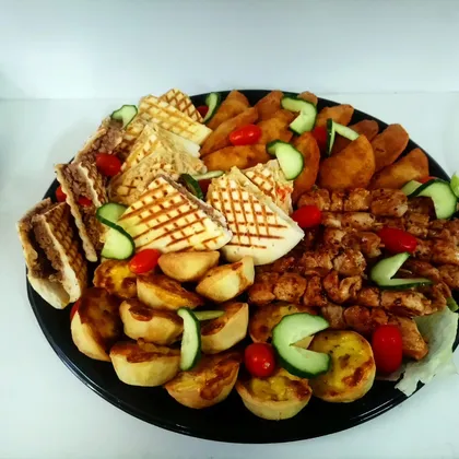 A savoury party platter with toasties, samoosas and chicken kebabs