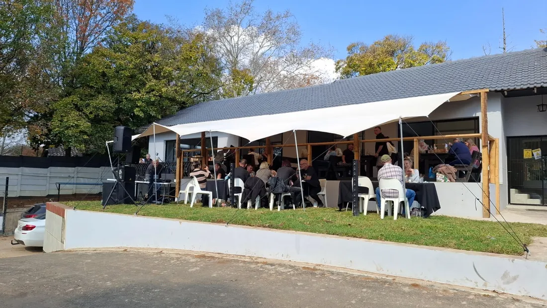 Diners under the stretch tent on the patio at Aunty Pat's Pantry on a clear Boksburg day